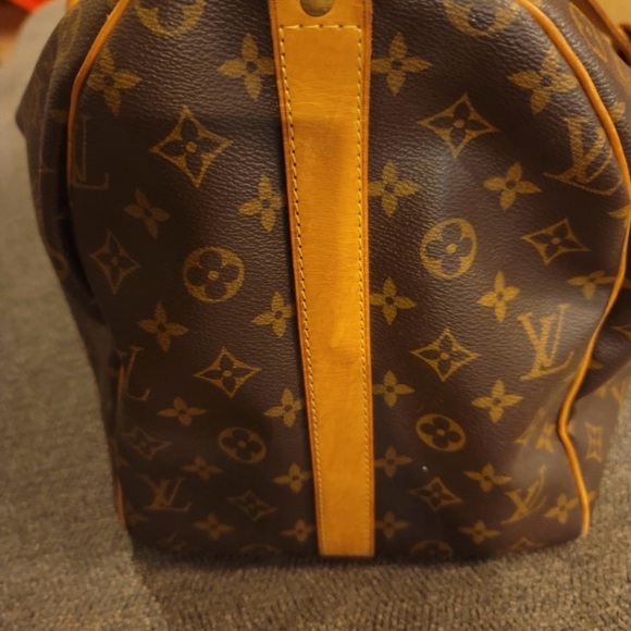 I’m selling a brown and tan Louis Vuitton travel bag. - Picture 2 of 7